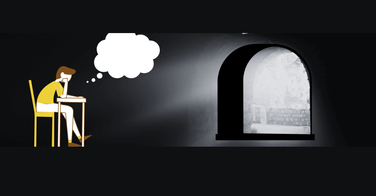A student seated in a dimly lit room, lost in contemplation